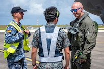 From left: A Royal Australian Air Force maintainer, a Japan Air Self Defense Force maintainer and U.S. Air Force Lt. Col. Mike Loringer, 134th Fighter Squadron pilot, speak with each other on the flight-line during exercise Cope North 25 at Andersen Air Force Base, Guam, Feb. 13, 2025.