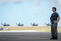 Japan Air Self Defense Force maintainer waits for a F-35A Lightning II to take-off on the flightline for exercise Cope North 25 at Andersen Air Force Base, Guam, Feb. 13, 2025