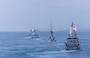 The Martadinata-class frigate KRI Raden Eddy Martadinata (331), the Kedah-class offshore patrol vessel KD Kelantan (F175), the Kedah-class offshore patrol vessel KD Selangor (F176), the Independence-class littoral mission vessel RSS Fortitude (20), and the Victory-class corvette RSS Valour (89) manuever ahead of the Arleigh Burke-class guided-missile destroyer USS Dewey (DDG 105) while in formation during Multinational Exercise Komodo (MNEK) 2025, in the Bali Sea, Feb. 16, 2025.
