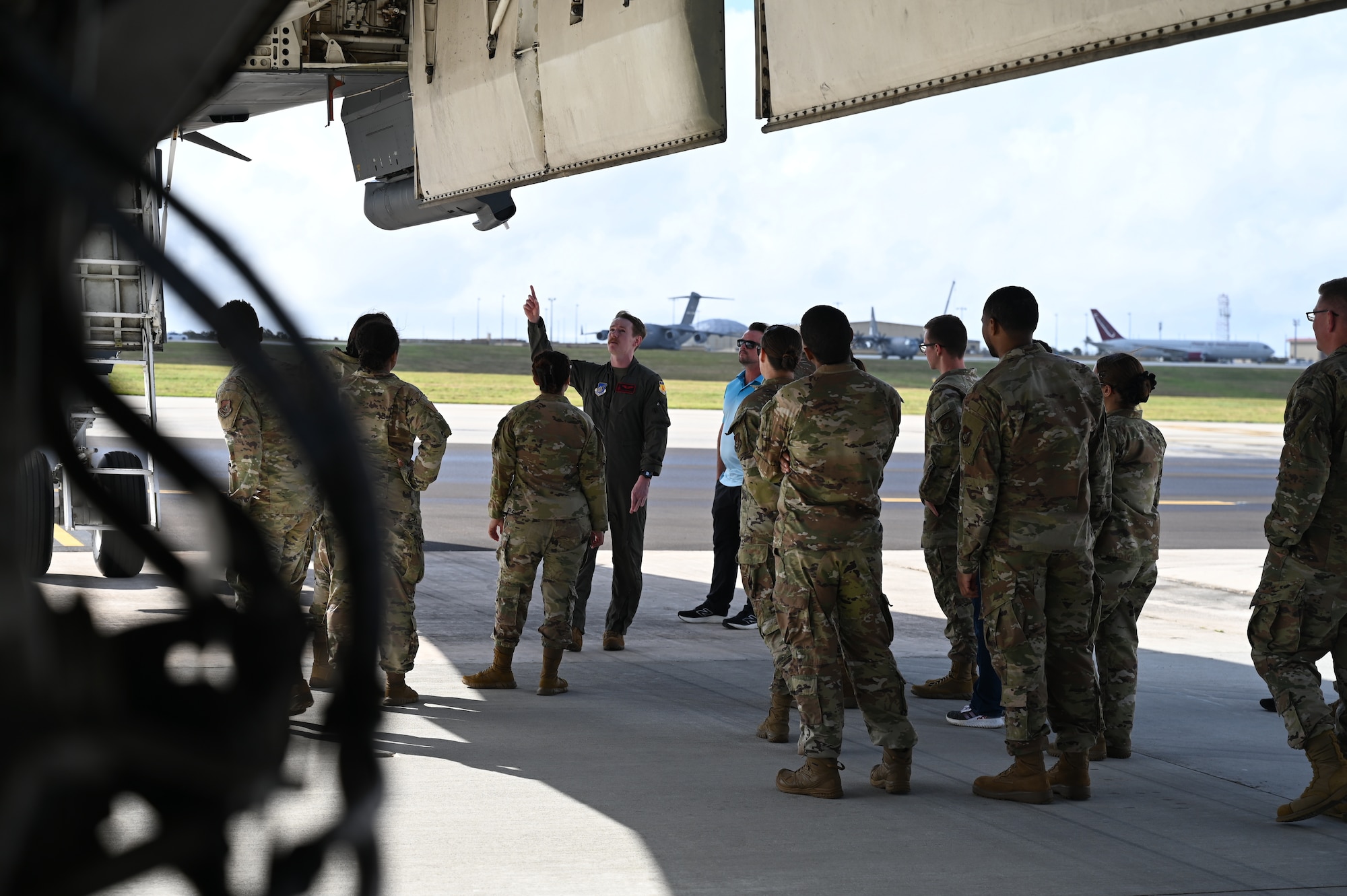 U.S. Air Force 36th Medical Group gather around a B-1B Lancer during their emersion tour at Andersen Air Force Base, Guam, Feb. 10, 2025. Carrying the largest conventional payload of both guided and unguided weapons in the Air Force inventory, the multi-mission B-1 is the backbone of America's long-range bomber force. (U.S. Air Force photo by Airman 1st Class Adasha Williams)