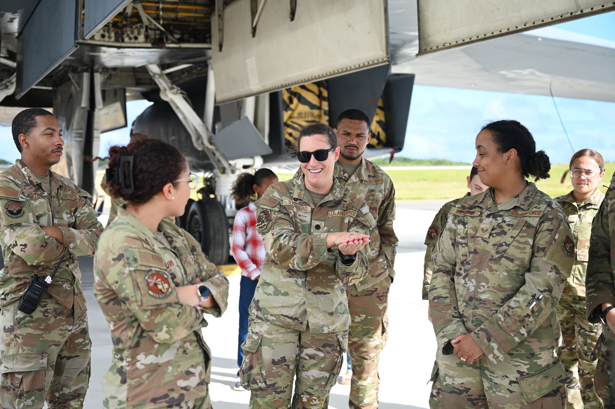 U.S. Air Force 36th Medical Group gather around a B-1B Lancer during their emersion tour at Andersen Air Force Base, Guam, Feb. 10, 2025. Carrying the largest conventional payload of both guided and unguided weapons in the Air Force inventory, the multi-mission B-1 is the backbone of America's long-range bomber force. (U.S. Air Force photo by Airman 1st Class Adasha Williams)