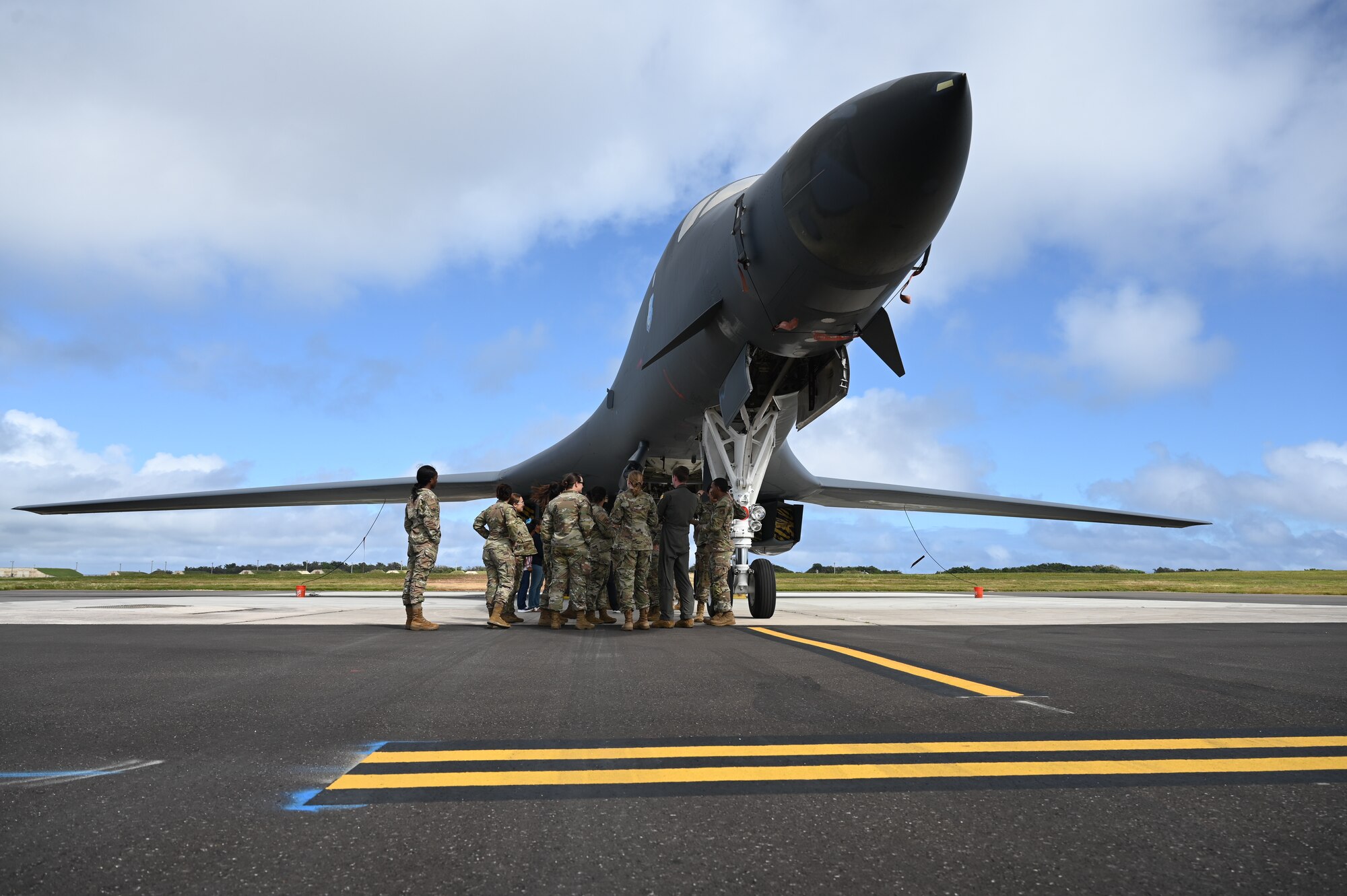 U.S. Air Force 36th Medical Group gather around a B-1B Lancer during their emersion tour at Andersen Air Force Base, Guam, Feb. 10, 2025. Carrying the largest conventional payload of both guided and unguided weapons in the Air Force inventory, the multi-mission B-1 is the backbone of America's long-range bomber force. (U.S. Air Force photo by Airman 1st Class Adasha Williams)
