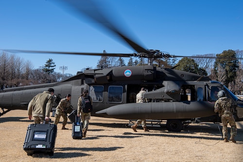 U.S. Air Force Airmen board a U.S. Army UH-60 Blackhawk.