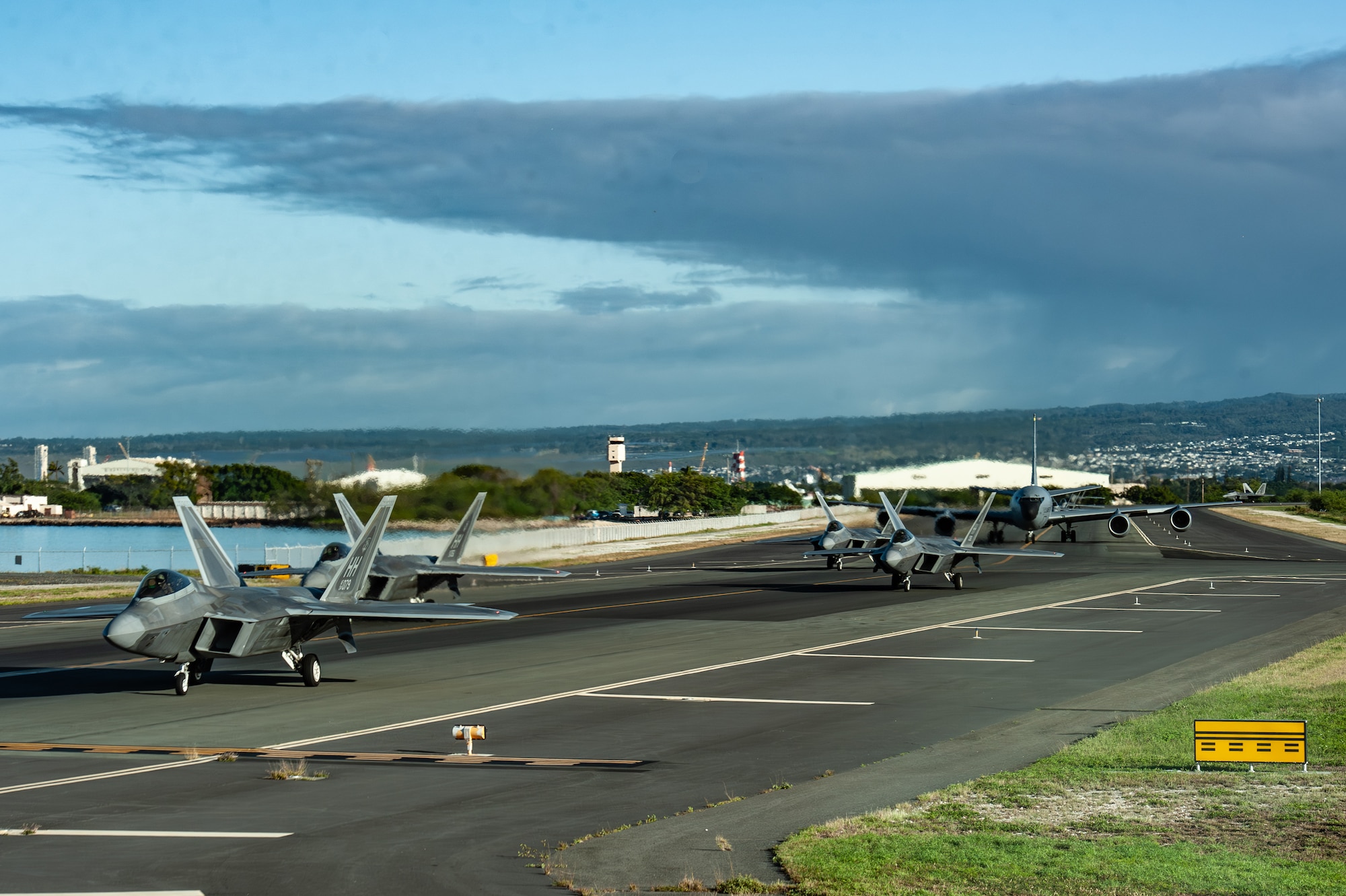 U.S. Air Force F-22A Raptors assigned to the 199th Fighter Squadron, operated by members of the 199th and 19th Fighter Squadrons, and a KC-135 Stratotanker assigned to the 203rd Air Refueling Squadron taxi the runway on Joint Base Pearl Harbor-Hickam, Hawaii, Feb 5, 2025, for Sentry Aloha 25-1. Fighter jets, tankers and support units participated in simulated combat scenarios, enhancing interoperability and readiness among U.S. military forces.