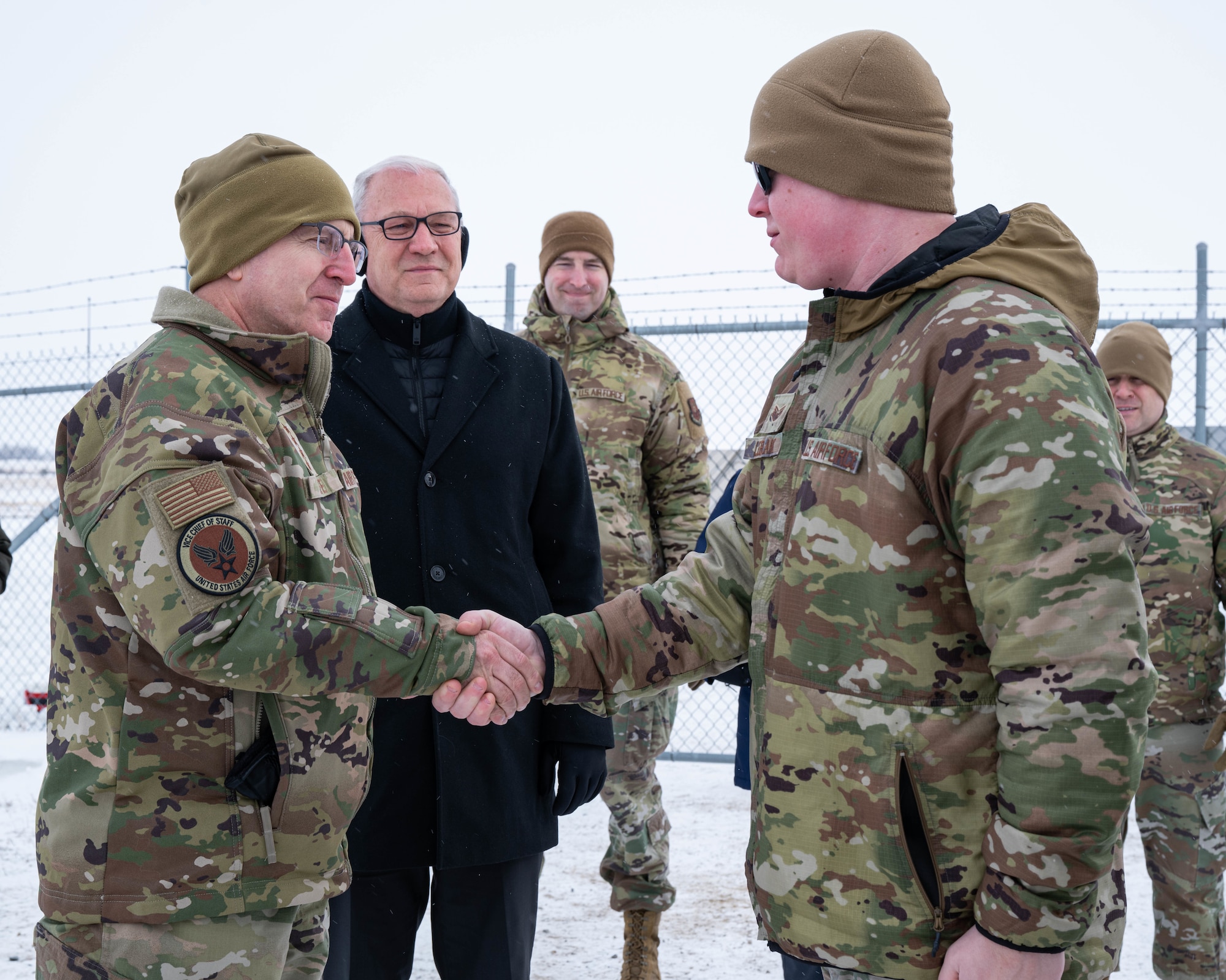 U.S. Air Force Gen. Jim Slife (left), Air Force vice chief of staff (VCSAF), coins U.S. Air Force Staff Sgt. Kai LeBlanc, 91st Missile Security Forces Squadron training instructor, during a base visit at a missile launch facility near Minot Air Force Base, North Dakota, Feb. 15, 2025. Slife presented LeBlanc with the coin as a recognition of exceptional performance. (U.S. Air Force photo by Senior Airman Kyle Wilson)