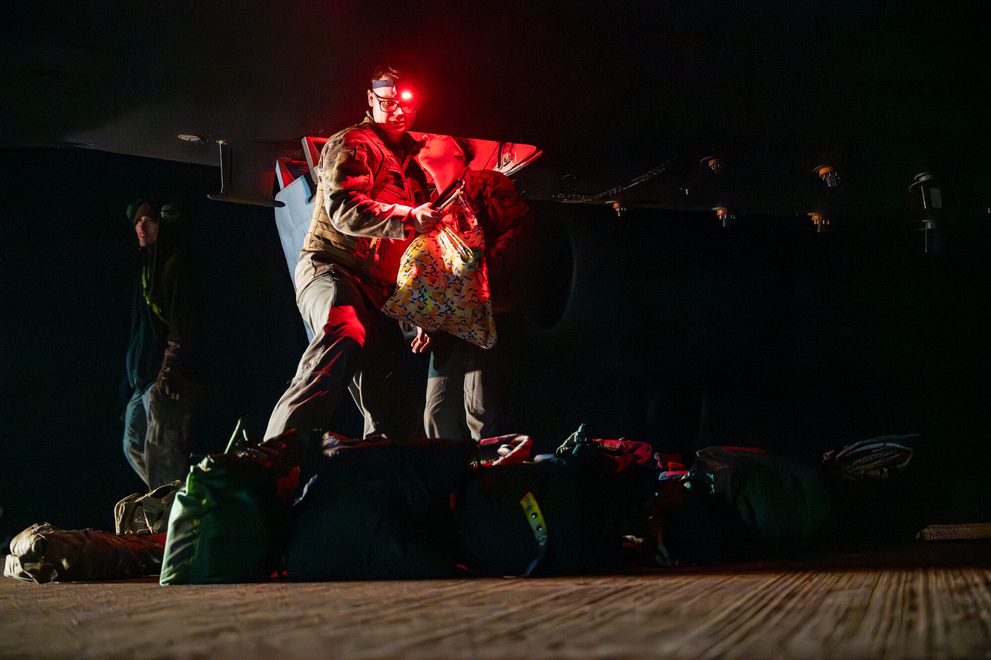 A U.S. Air Force aircrew member removes flight gear after returning from a sortie in support of the Bomber Task Force 25-2 deployment at RAF Fairford, England, Feb. 18, 2025. Regular bomber presence in Europe reinforces U.S. security commitments to NATO. (U.S. Air Force photo by Staff Sgt. Kristen Heller)