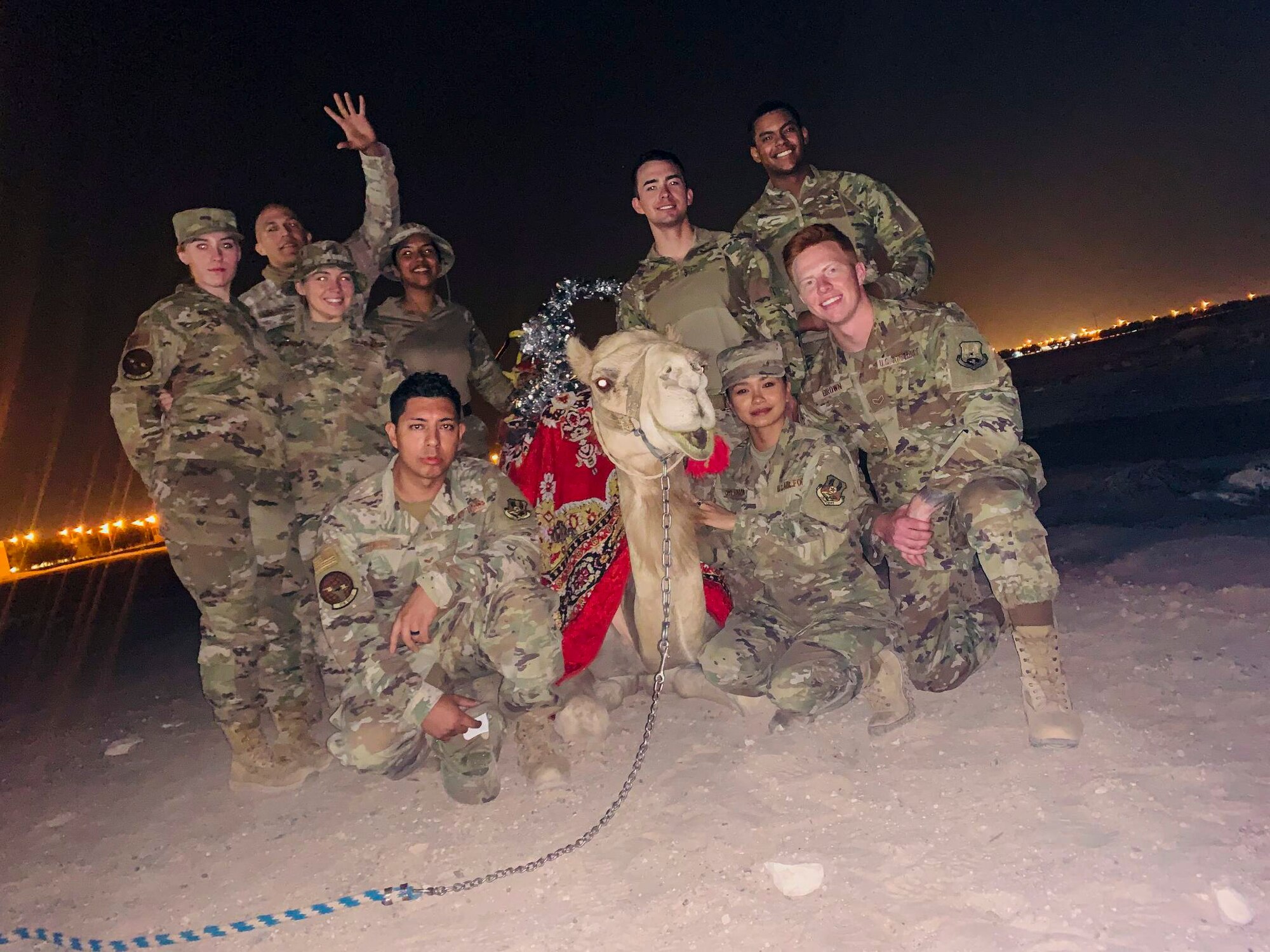 U.S. Air Force Staff Sgt. Hector De Los Santos, 378th Expeditionary Force Support Squadron lodging noncommissioned officer in charge, and U.S. Air Force Senior Airman Hana De Los Santos, 378th Expeditionary Force Support Squadron command support staff, pose with a group of 378th Air Expeditionary Wing Airmen in a U.S. Central Command area of responsibility, Sept. 25, 2020.