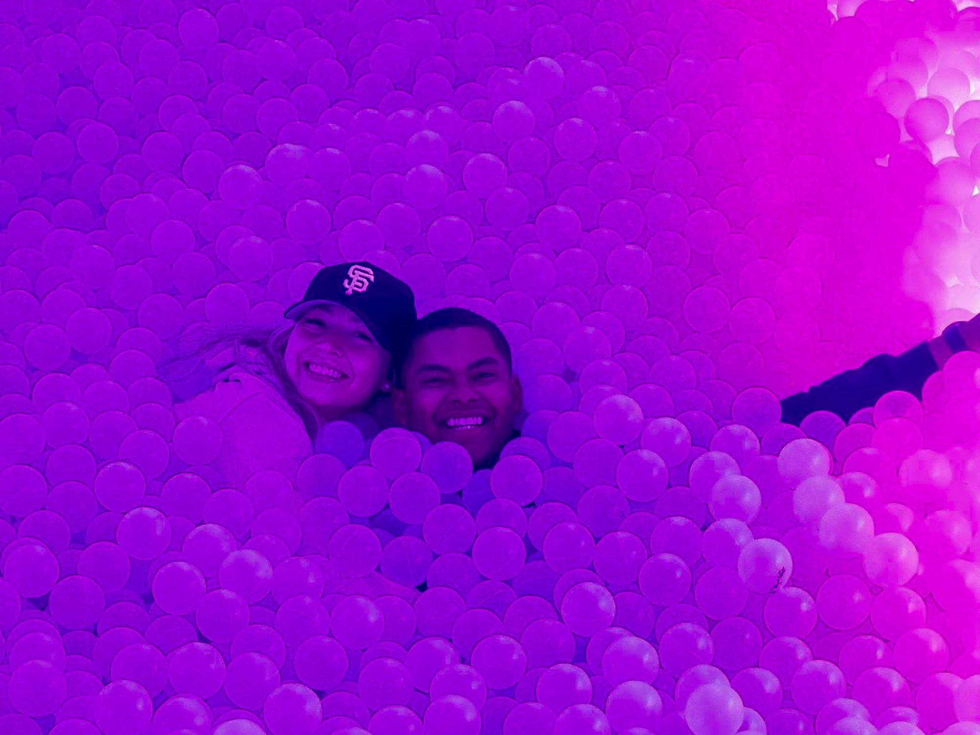 U.S. Air Force Staff Sgt. Hector De Los Santos, 378th Expeditionary Force Support Squadron lodging noncommissioned officer in charge, and U.S. Air Force Senior Airman Hana De Los Santos, 378th Expeditionary Force Support Squadron command support staff, take a photo in the House of Hype at Boulevard City in a U.S. Central Command area of responsibility, Dec. 29, 2024.