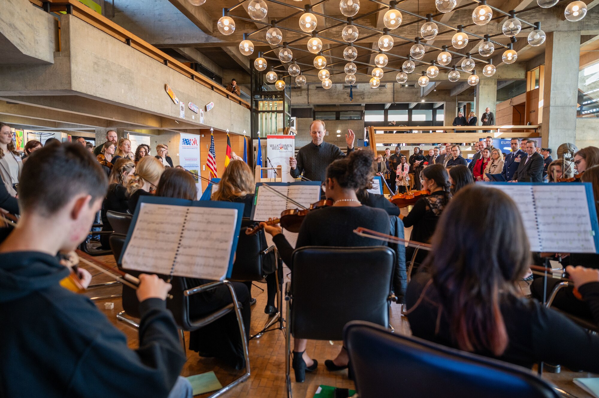 The Ramstein High School string ensemble performs at an art exhibition opening for the 22nd German American Community Office anniversary in Kaiserslautern, Germany, Feb. 18, 2025. The string ensemble performed throughout the exhibition, showcasing enduring partnerships between the schools and local community.