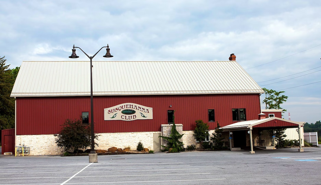 Photo is of a large red building with the name Susquehanna Club placed on the front.