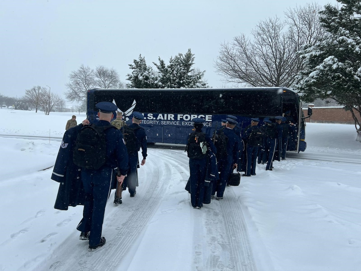 Honor Guard members walking to coach bus