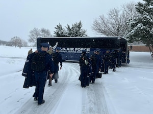 Honor Guard members walking to coach bus