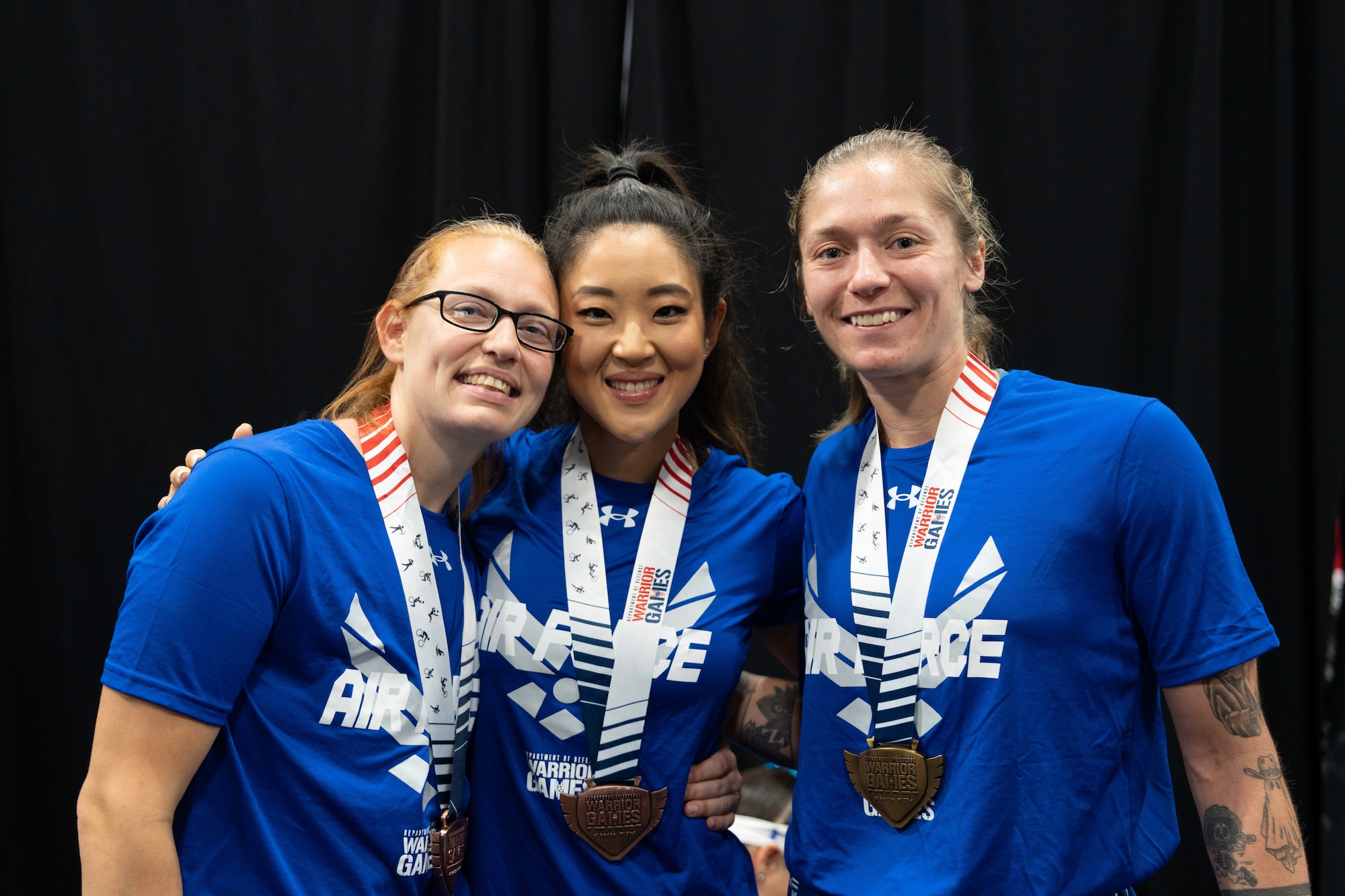 2024 Warrior Games Powerlifting medalists, TSgt Jessica Derhammer (ret), Capt Christina Kang (ret), and SSgt Allison Smith (from left to right) shortly after competition