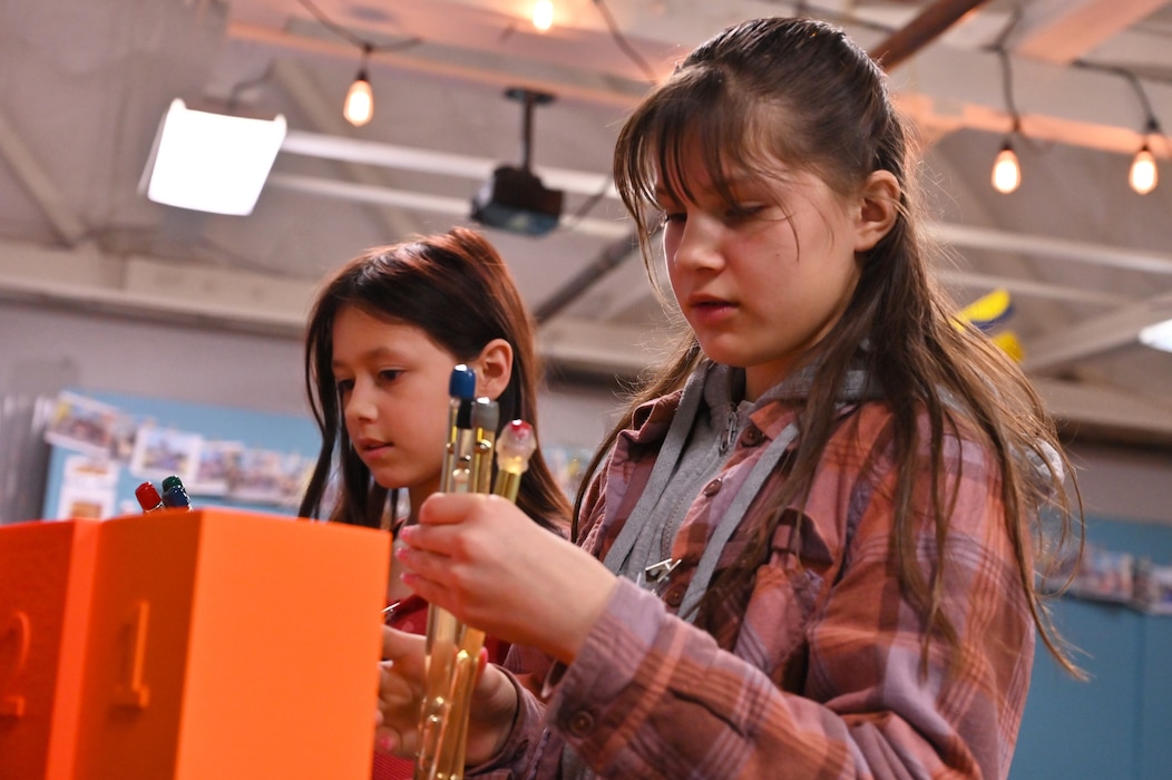Two students gather supplies