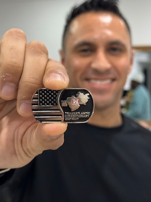 U.S. Army Lt. Col. Eder C. Ramirez, U.S. Army Corps of Engineers Expeditionary District commander, holds the district's new challenge coin before presenting it to selected individuals recognized for excellence at a townhall during District Governance Week in Kuwait, on January 14, 2025.