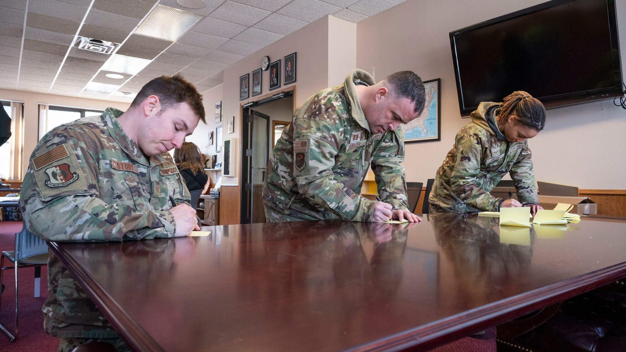 Airmen from the True North program write about what they are thankful for at the Northern Lights Chapel on Minot Air Force Base, North Dakota, Feb. 12, 2025. True North is a resiliency program that embeds highly accessible social workers and chaplains within squadrons and groups in an effort to provide service members and their authorized dependents the services necessary to remain spiritually fit. (U.S. Air Force photo by Senior Airman Kendra A. Ransum)