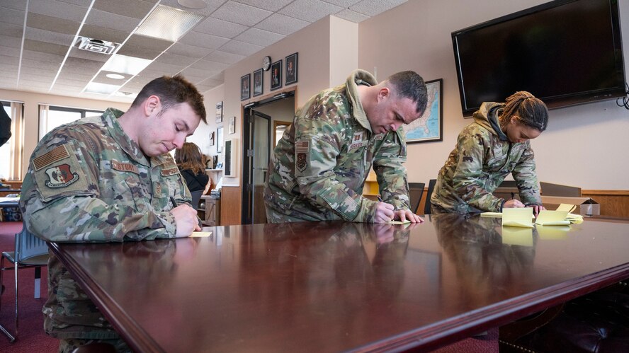 Airmen from the True North program write about what they are thankful for at the Northern Lights Chapel on Minot Air Force Base, North Dakota, Feb. 12, 2025. True North is a resiliency program that embeds highly accessible social workers and chaplains within squadrons and groups in an effort to provide service members and their authorized dependents the services necessary to remain spiritually fit. (U.S. Air Force photo by Senior Airman Kendra A. Ransum)