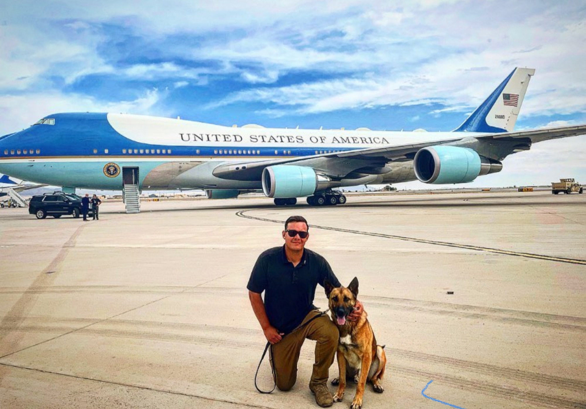 Military Working Dog Bob and his handler, SSgt Brandon Soto, 377th Security Forces Group, pose in front of air force one.