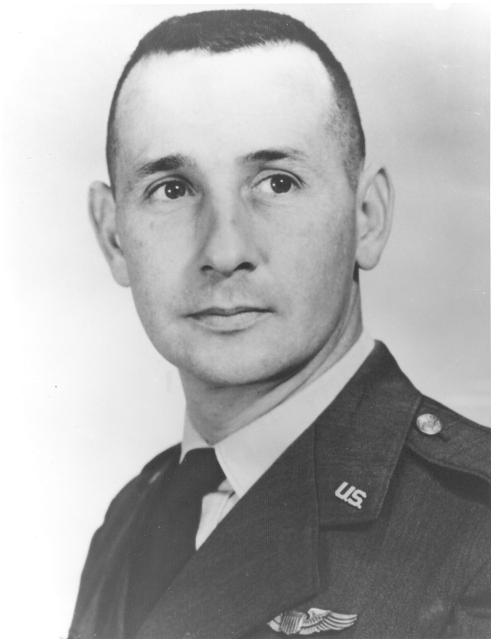 A man in uniform poses for a photo.