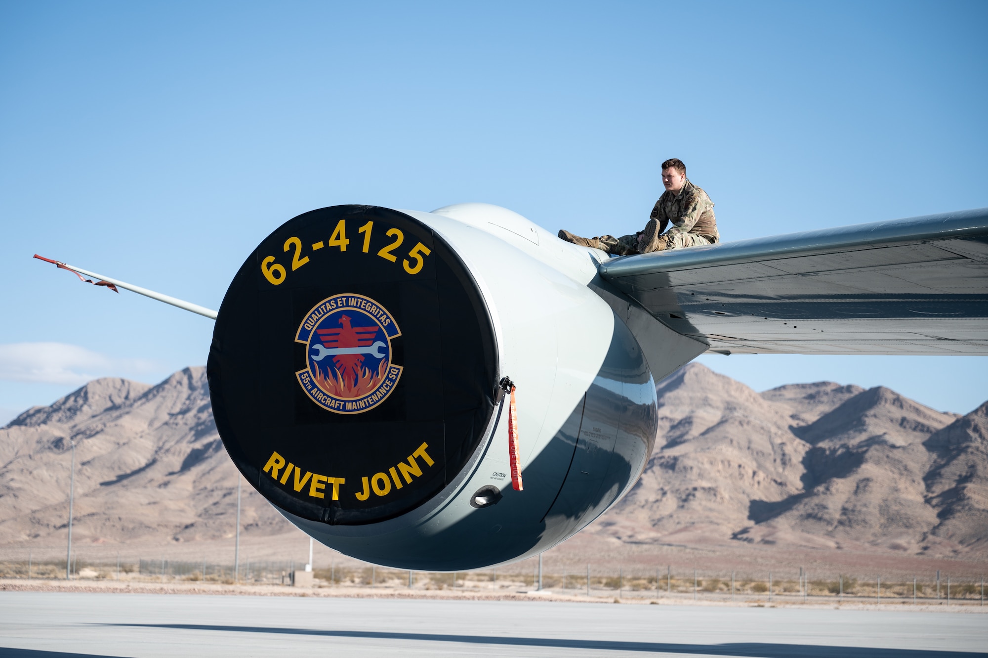 Senior Airman Craig Moccia, 55th Aircraft Maintenance Squadron dedicated crew chief, opens a panel on a RC-135V/W Rivet Joint before Red Flag 25-1 at Nellis Air Force Base, Nevada Jan. 26, 2025. Moccia ensured that the hydraulic fluids were within operational specification and fully functional for an upcoming flight. (U.S. Air Force photo by Tech. Sgt. Chris Thornbury)