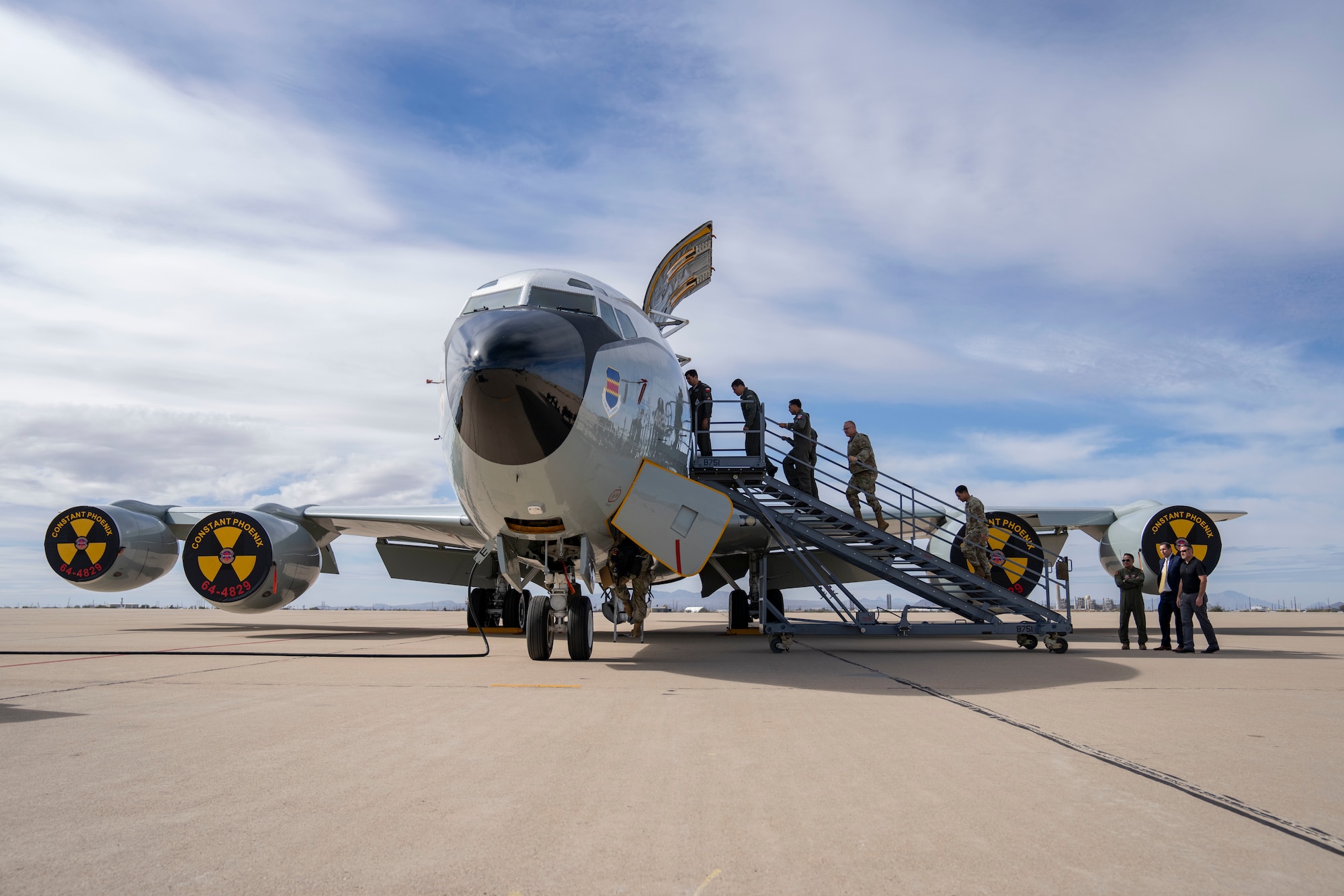 Air Forces Southern Foreign Liaison Officers and personnel board a WC-135 Constant Phoenix aircraft for a tour, Feb. 13, 2025 at Davis-Monthan Air Force Base, Arizona. The WC-135, which traveled from Offutt AFB, Nebraska, plays a critical role in nuclear treaty monitoring by collecting airborne effluents and particulates. (U.S. Air Force Photo by Andrea Jenkins)