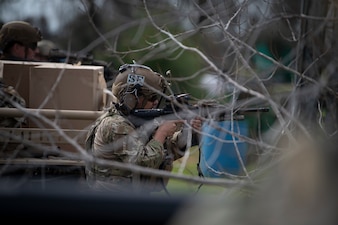 Man aims weapon