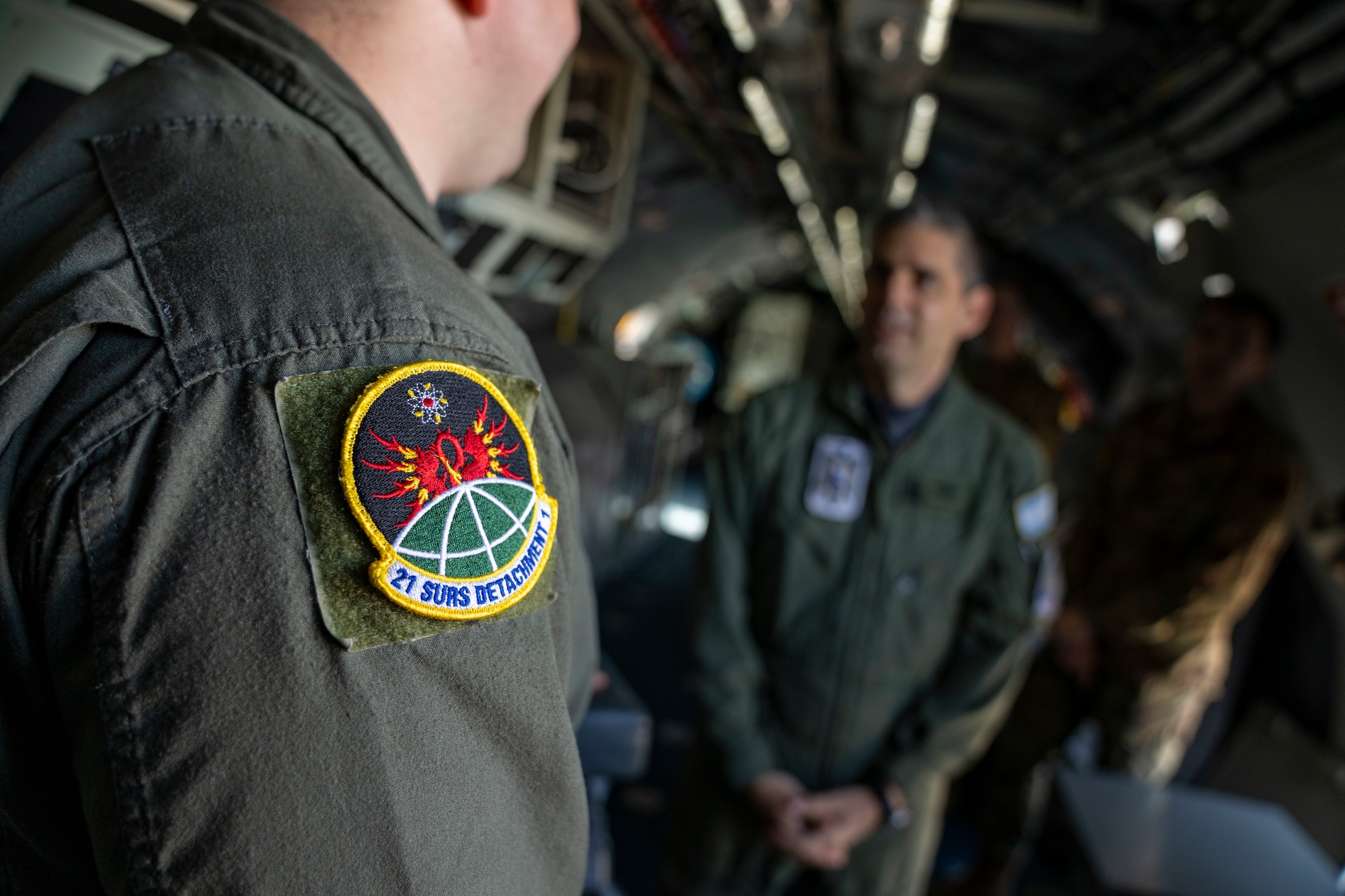 U.S. Air Force Tech. Sgt. Richard Westra, special equipment operator assigned to the 21st Surveillance Squadron, Det. 1, briefs Air Forces Southern Foreign Liaison Officers during a tour of a WC-135 Constant Phoenix aircraft, Feb. 13, 2025 at Davis-Monthan AFB, Arizona. The WC-135, which traveled from Offutt AFB, Nebraska, plays a critical role in nuclear treaty monitoring by collecting airborne effluents and particulates. (U.S. Air Force Photo by Andrea Jenkins)