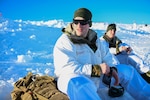 U.S. Army 1st Lt. Trevor Dufault of the Minnesota National Guard takes a break during a field training exercise on a mountaintop near Haltdalen, Norway, Feb. 11, 2025. During the exercise, service members built snow caves where they slept at night.