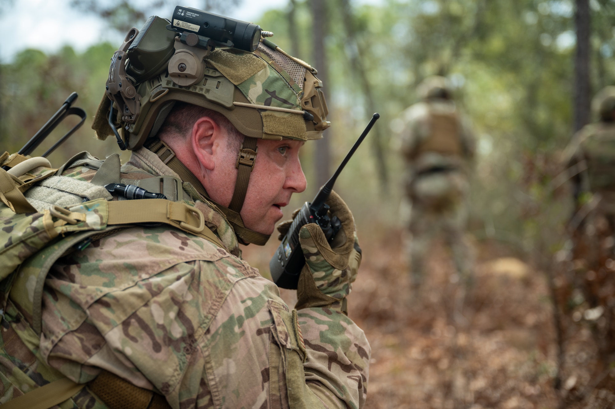 Close-up shot of an Airmen speaking into a walkie-talkie.