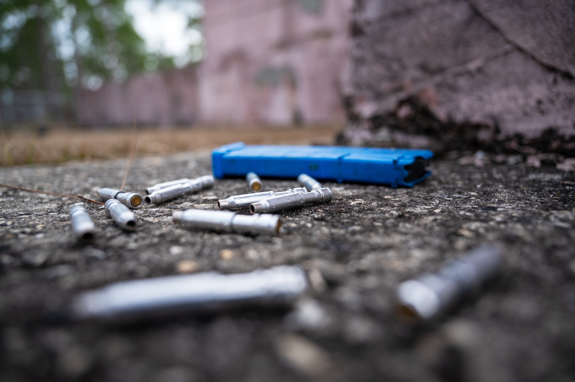 Non-lethal training cartridges dispersed on the ground during a field training exercise