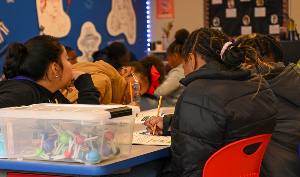 Students write in a workbook