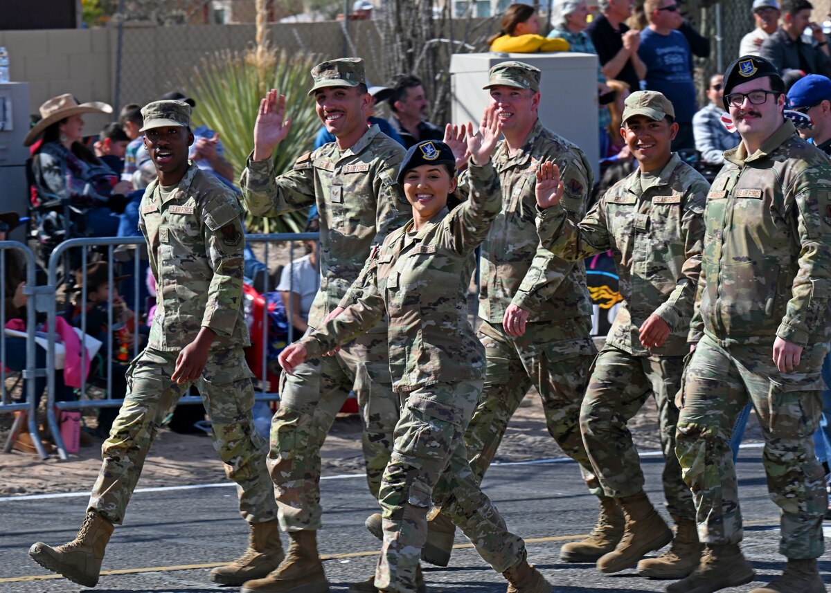 U.S. Airmen assigned to the 355th Wing participate in the 100th Annual Tucson Rodeo Parade in Tucson, Arizona, Feb. 20, 2025. The Airmen attended the parade to represent Davis-Monthan Air Force Base, which is one of the largest installations and flying operations in the United States Air Force, to the community.  (U.S. Air Force photo by Staff Sgt. Abbey Rieves)