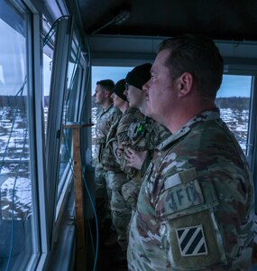 U.S. Soldiers assigned to 5th Battalion, 7 Calvary Regiment, 1st Armored Brigade Combat Team, 3rd Infantry Division, observe the impact area during HIMARS (High Mobility Artillery Rocket System) live fire rehearsal near Camp Tappa, Estonia, Jan. 26, 2025. The 13Fs, Forward Observers, assessed the best location to fire the HIMARS based on the visuals in the overlook tower and verbally relayed the information with the Fire Support Element on the ground and transferred information to the HIMARS operators. (U.S. Army Photo by Sgt. Kourtney Nunnery)