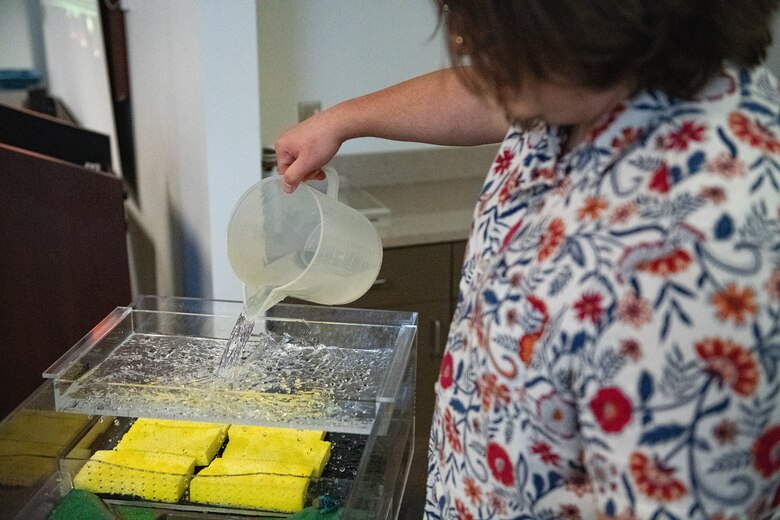 a man pours water into a terrain model