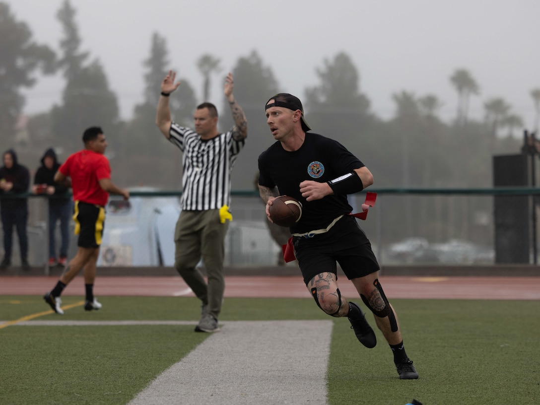 U.S. Marine Corps Sgt. Jordin Foth, an influence operations specialist, with 1st Information Maneuver Company, I Marine Expeditionary Force Information Group, plays in the I MIG Hammer Bowl at Paige Field House on Marine Corps Base Camp Pendleton, California, Feb. 7, 2025. The I MIG Hammer Bowl demonstrates the I MIG Marines’ physical prowess, camaraderie, and espirit de corps. (U.S. Marine Corps photo by Lance Cpl. Fabian Ortiz)