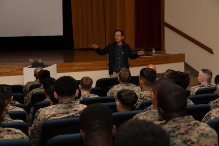 Ken Hirano, the Marine and Family Life counselor of 3rd Marine Logistics Group (3rd MLG), speaks during a Korean Marine Exchange Program pre-deployment brief at Camp Kinser, Okinawa, Japan, Feb. 6, 2025. Marines and Sailors with 3rd MLG attended a pre-deployment brief designed to equip them with essential information on operational readiness, mental resilience, and support services to help them transition smoothly into their deployment. (U.S. Marine Corps photo by Lance Cpl. Rachel Mason)