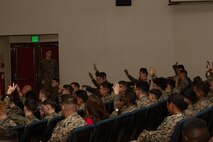 U.S. Marines and Sailors with 3rd Marine Logistics Group (3rd MLG) raise their hands in response to a question during a Korean Marine Exchange Program pre-deployment brief at Camp Kinser, Okinawa, Japan, Feb. 6, 2025. Marines and Sailors with 3rd MLG attended a pre-deployment brief designed to equip them with essential information on operational readiness, mental resilience, and support services to help them transition smoothly into their deployment. (U.S. Marine Corps photo by Lance Cpl. Rachel Mason)