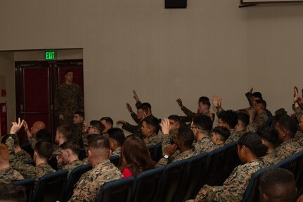 U.S. Marines and Sailors with 3rd Marine Logistics Group (3rd MLG) raise their hands in response to a question during a Korean Marine Exchange Program pre-deployment brief at Camp Kinser, Okinawa, Japan, Feb. 6, 2025. Marines and Sailors with 3rd MLG attended a pre-deployment brief designed to equip them with essential information on operational readiness, mental resilience, and support services to help them transition smoothly into their deployment. (U.S. Marine Corps photo by Lance Cpl. Rachel Mason)