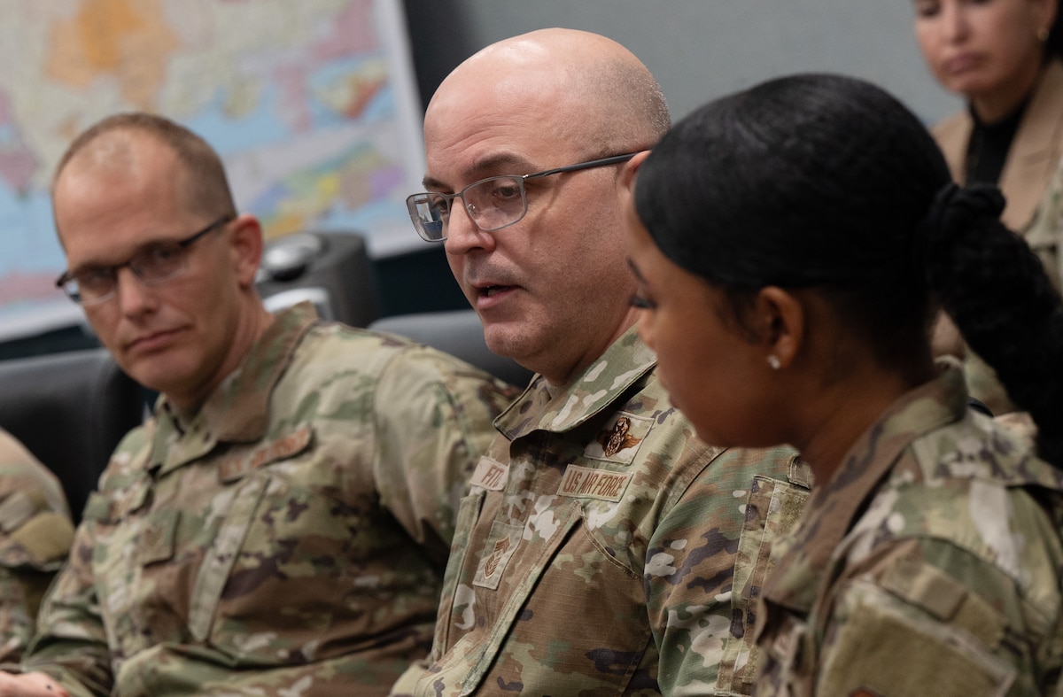 Air Force Materiel Command command chief talks with junior force members.