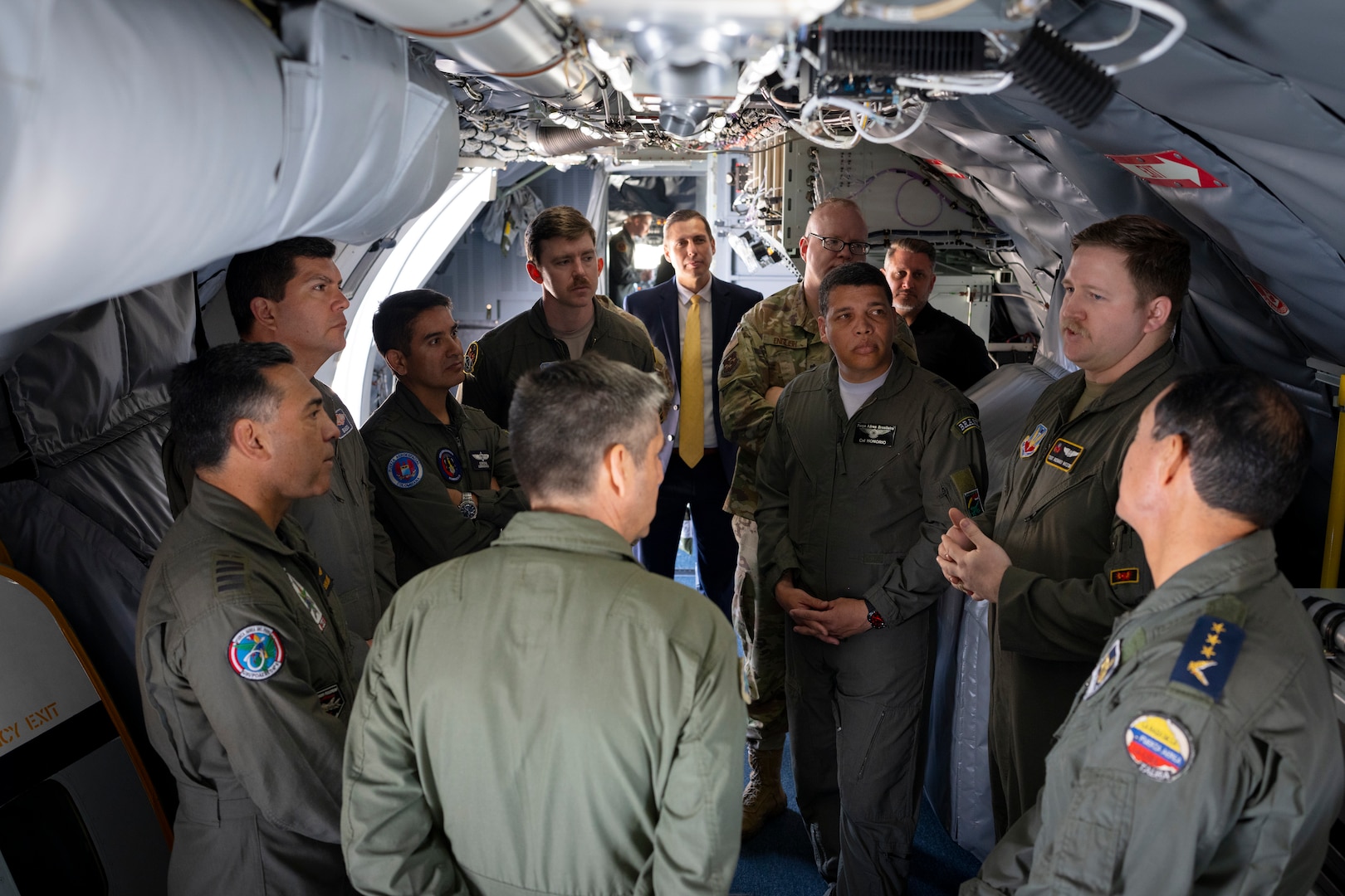 Foreign Liaison Officers with Air Forces Southern tour the inside of a WC-135 Constant Phoenix aircraft, Feb. 13, 2025 at Davis-Monthan Air Force Base, Arizona. The FLOs who represent Colombia, Peru, Brazil, Chile, Argentina, and Ecuador gained insight into the aircraft’s mission and capabilities, fostering stronger ties to support future collaborations in detecting and deterring nuclear threats in the U.S. Southern Command region. (U.S. Air Force Photo by Tech. Sgt. Rachel Maxwell)