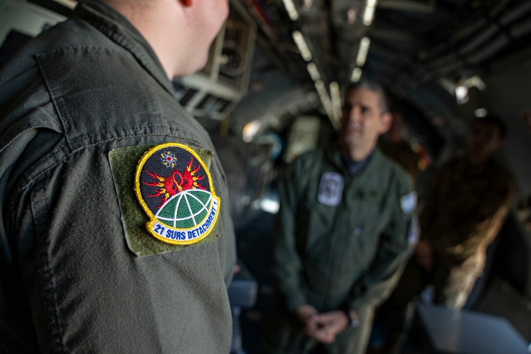 U.S. Air Force Tech. Sgt. Richard Westra, special equipment operator assigned to the 21st Surveillance Squadron, Det. 1, briefs Air Forces Southern Foreign Liaison Officers during a tour of a WC-135 Constant Phoenix aircraft, Feb. 13, 2025 at Davis-Monthan AFB, Arizona. The WC-135, which traveled from Offutt AFB, Nebraska, plays a critical role in nuclear treaty monitoring by collecting airborne effluents and particulates. (U.S. Air Force Photo by Andrea Jenkins)