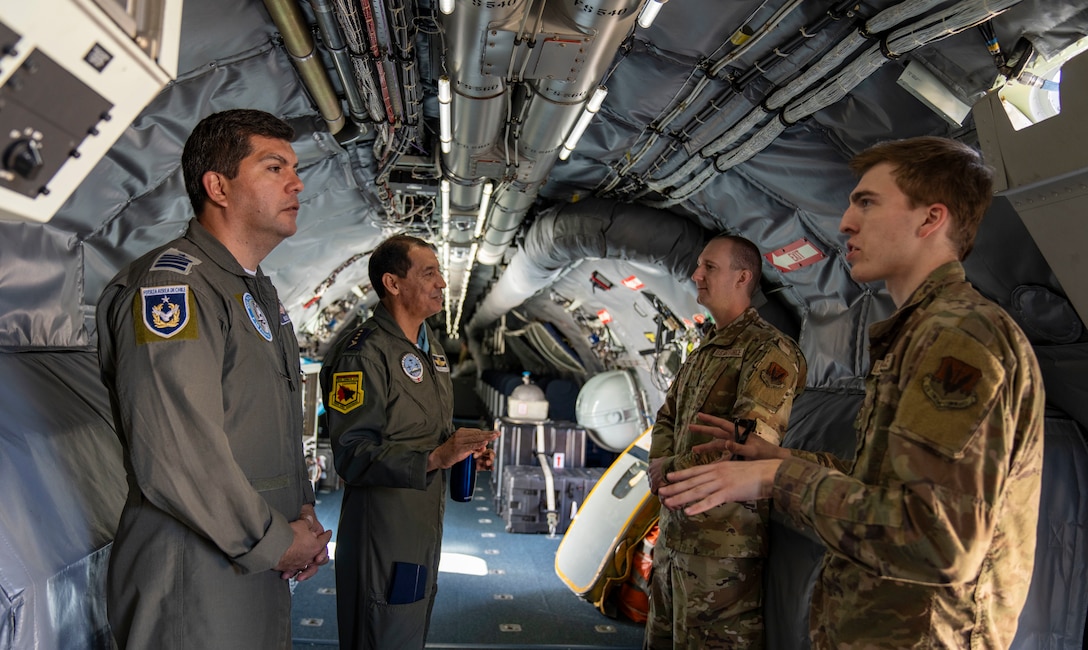 Chilean Air Force Col. Ignacio Baeza, left, and Ecuadorean Air Force Col. José Guerrero, left-center, Air Forces Southern Foreign Liaison Officers, receive a mission brief from U.S. Air Force personnel from the 21st Surveillance Squadron, Det. 1, during a tour of a WC-135 Constant Phoenix aircraft, Feb. 13, 2025 at Davis-Monthan Air Force Base, Arizona. FLOs serve as key representatives of their home nations’ air forces within Air Forces Southern, the air component of U.S. Southern Command. They facilitate communication, coordination, and cooperation between the U.S. and partner nations, strengthening military relationships and enhancing regional security efforts. (U.S. Air Force Photo by Andrea Jenkins)