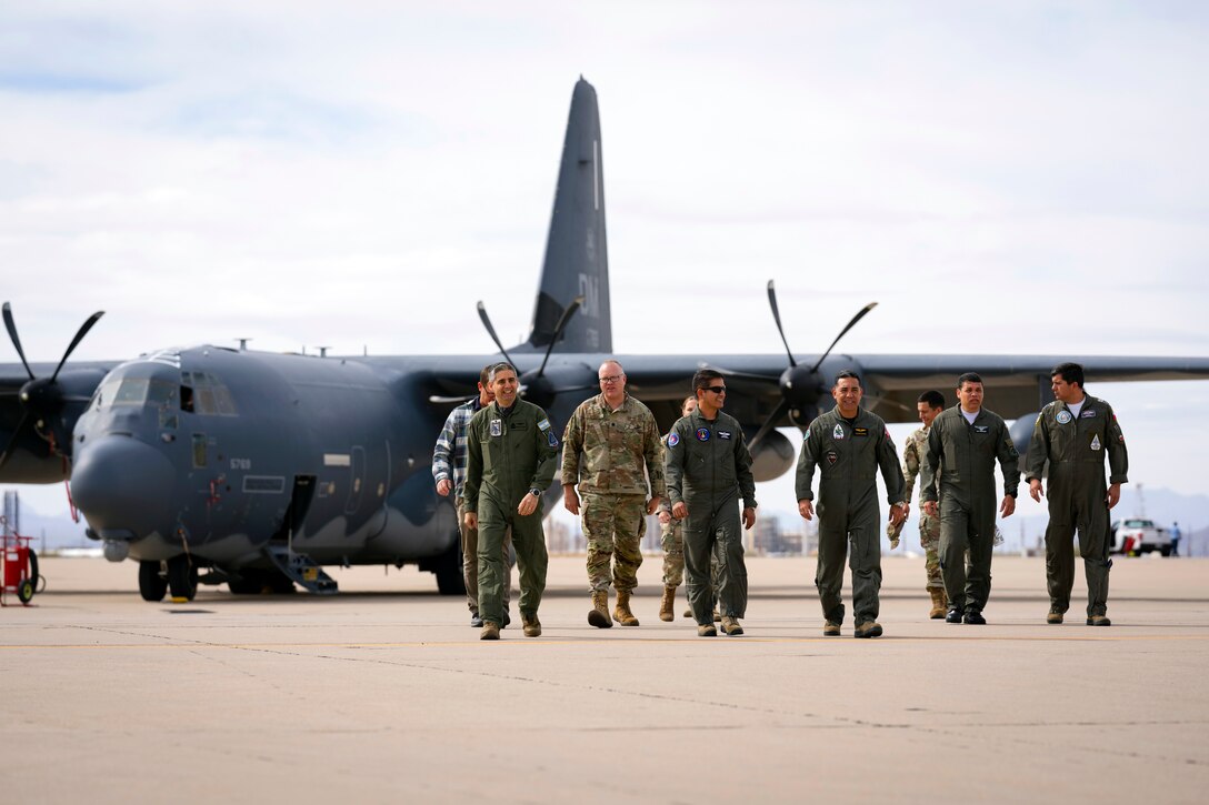 Air Forces Southern Foreign Liaison Officers and personnel walk the flightline after touring a HC-130J Combat King II assigned to the 355th Wing, Feb. 13, 2025 at Davis-Monthan Air Force Base, Arizona. The hands-on immersion provided valuable background and broadened perspectives on U.S. Air Force capabilities, reinforcing the U.S. military’s ongoing commitment to fostering international cooperation and ensuring security and stability in the U.S. Southern Command region. (U.S. Air Force Photo by Tech. Sgt. Rachel Maxwell)