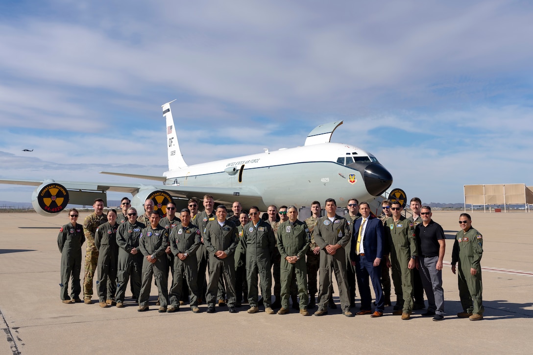 Airmen assigned to the 55th Wing and personnel from Air Forces Southern assemble for a group photo in front of a WC-135 Constant Phoenix aircraft, Feb. 13, 2025 at Davis-Monthan Air Force Base, Arizona. The immersion helped to provide a firsthand look about the aircraft’s capabilities and its role in nuclear treaty monitoring, reinforcing transparency and collaboration in countering threats. (U.S. Air Force Photo by Tech. Sgt. Rachel Maxwell)