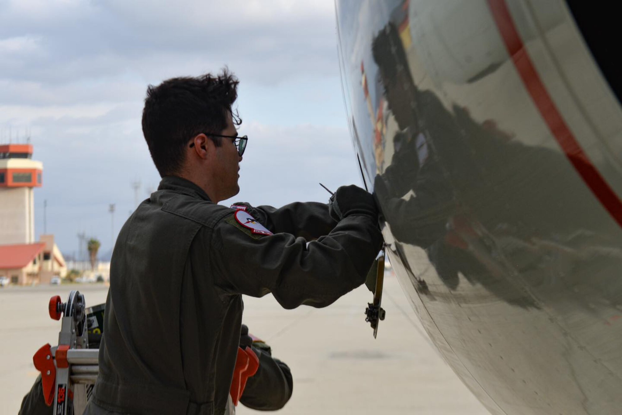 An RC-135V/W Rivet Joint aircrew from 343rd Reconnaissance Squadron, 97th Intelligence Squadron, 49th  IS, and the Royal Air Force 51st Squadron refuel at March Air Force Base during Bamboo Eagle 11, 2025. Members of the regular aircrew serviced the aircraft's fuel and other systems to ensure it was capable of executing it tasked mission safely to test and demonstrate the unique capability to have aircrew fill non-standard roles that further enable resilient and flexible logistics in support of agile combat employment to increase force survivability. (U.S. Air Force photo by Capt. Patrick Butler)