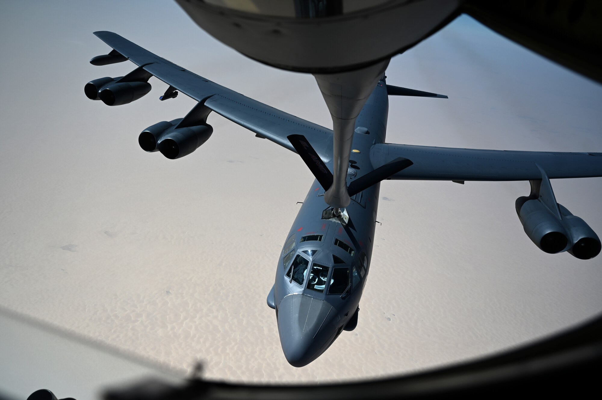 An aircraft refuels an aircraft.