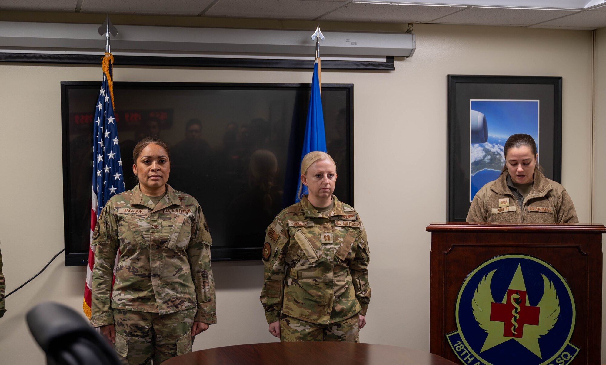 Service members stand at attention.