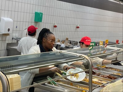 Zana Edmonds, the Stronger Together Café Warrior Restaurant manager, helps serve lunch at the café Feb. 20. Recently, Logistics Readiness Center Wiesbaden received a note praising the dining facility and specifically Edmonds for supporting more than 50 high school wrestlers from Ramstein who had dinner there Feb. 6 and 7 during the 2025 DoDEA Europe Wrestling Championships. (U.S. Army courtesy photo)