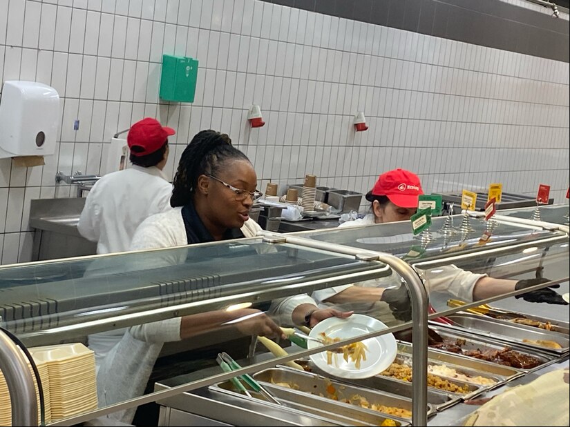 Zana Edmonds, the Stronger Together Café Warrior Restaurant manager, helps serve lunch at the café Feb. 20. Recently, Logistics Readiness Center Wiesbaden received a note praising the dining facility and specifically Edmonds for supporting more than 50 high school wrestlers from Ramstein who had dinner there Feb. 6 and 7 during the 2025 DoDEA Europe Wrestling Championships. (U.S. Army courtesy photo)