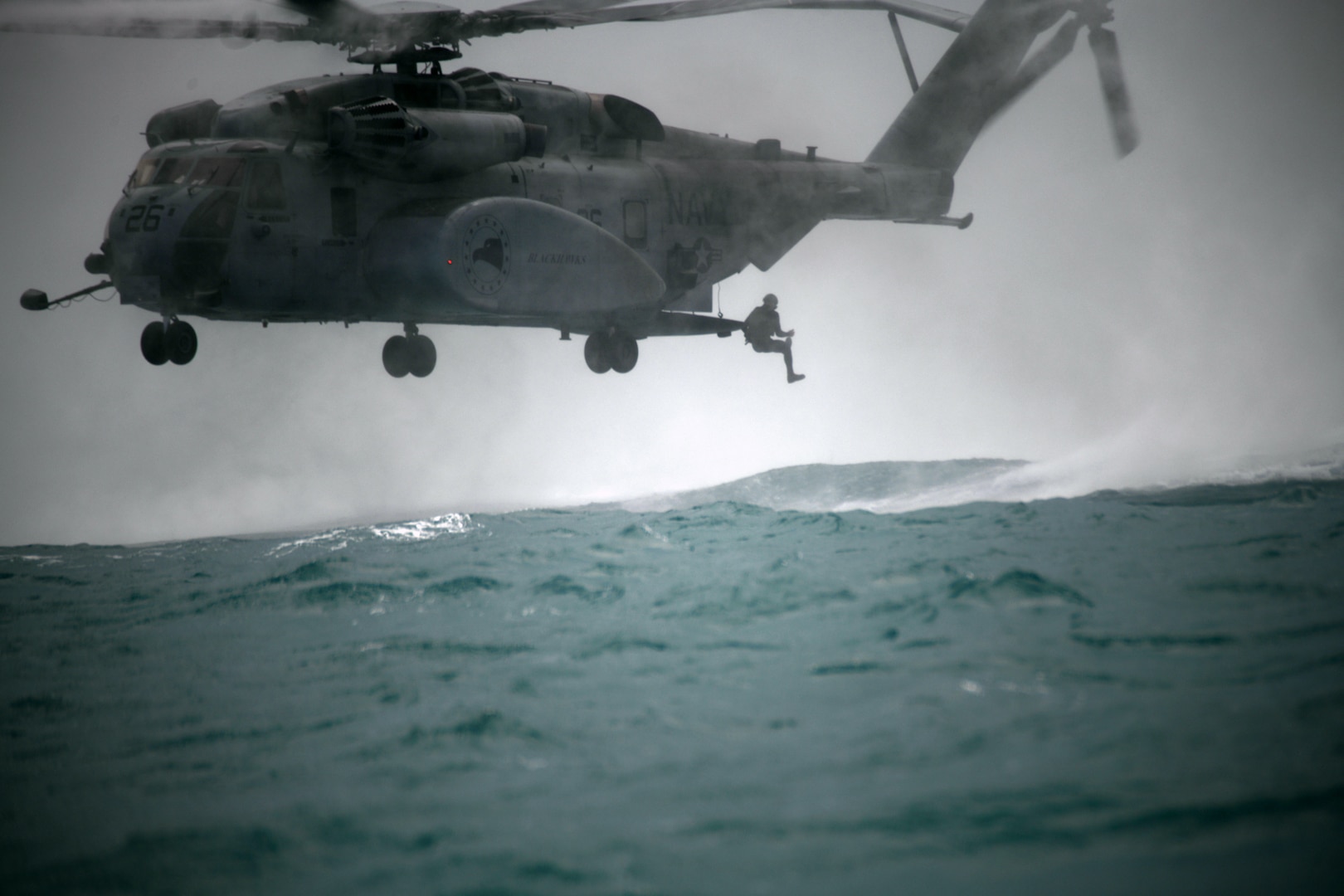 250218-N-PL185-1209 U.S. CENTRAL COMMAND AREA OF RESPONSIBILITY (Feb. 18, 2025) Divers leap from an MH-53E Sea Dragon helicopter, attached to Helicopter Mine Countermeasures Squadron (HM) 15, for floating mine response operations during International Maritime Exercise (IMX) 2025 in Manama, Bahrain. IMX25 is the largest multinational training event in the Middle East, involving 5,000 personnel from around 30 nations and international organizations committed to preserving the rules-based international order and strengthening regional maritime security cooperation. (U.S. Navy photo by Mass Communication Specialist 1st Class Lorenzo John Burleson)